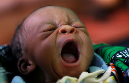 A newly born Congolese child yawns inside the maternity ward at the Kapangu maternity health centre in Kaniki-Kapangu near Mwene Ditu in Kasai Oriental Province in the Democratic Republic of Congo, March 15, 2018. Picture taken March 15, 2018. REUTERS/Thomas Mukoya