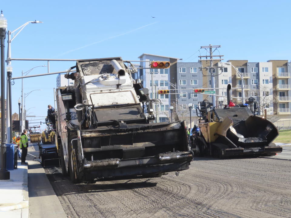 Heavy equipment repaves part of Atlantic Avenue in Atlantic City, N.J. on Dec. 13, 2023 as the city's controversial "road diet" project to narrow the main roadway from two lanes in each direction to one began. Five casinos and a hospital are asking a judge to order a halt to the plan, saying it could dangerously worsen traffic in the seaside gambling resort. (AP Photo/Wayne Parry)