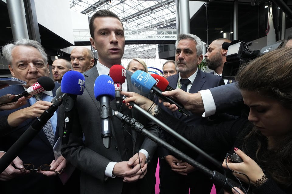 Jordan Bardella, president of the far-right National Front party, arrives at the Eurosatory Defense and security exhibition, Wednesday, June 19, 2024 in Villepinte, north of Paris. Jordan Bardella, the National Rally president hoping to become France's prime minister, appealed Tuesday to voters to hand his party a clear majority after French President Emmanuel Macron's announcement on June 9 that he was dissolving France's National Assembly, parliament's lower house.( AP Photo/Michel Euler)