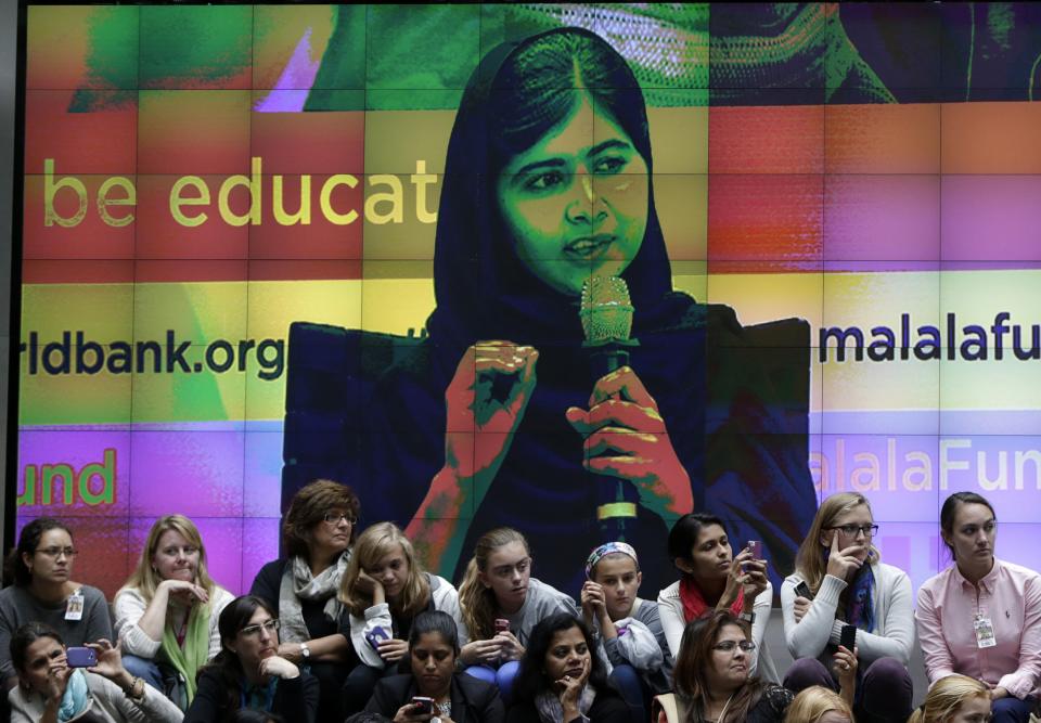 Video screen image of Malala Yousafzai is projected as she attends a news conference with World Bank President Jim Yong Kim in Washington