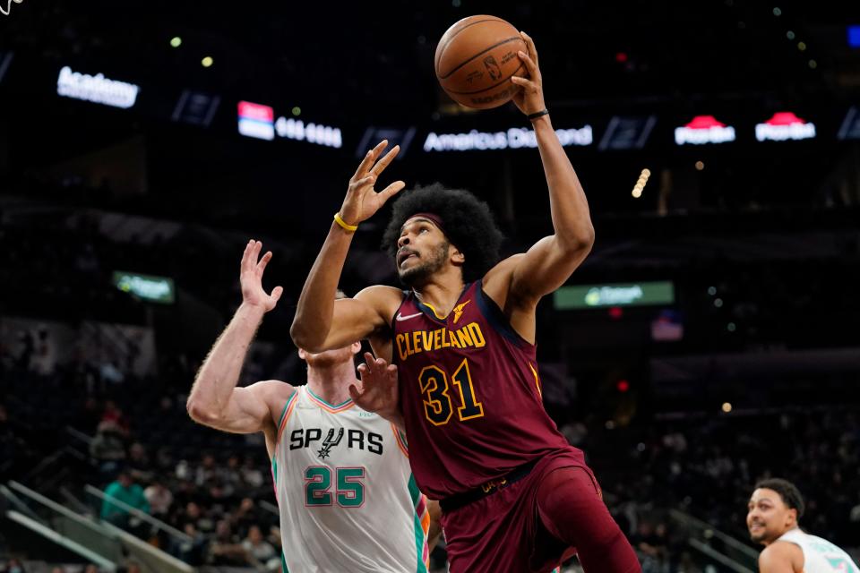 Cavaliers center Jarrett Allen (31) shoots over San Antonio Spurs center Jakob Poeltl (25) during the first half of the Cavs' 114-109 win Friday night in San Antonio. [Eric Gay/Associated Press]