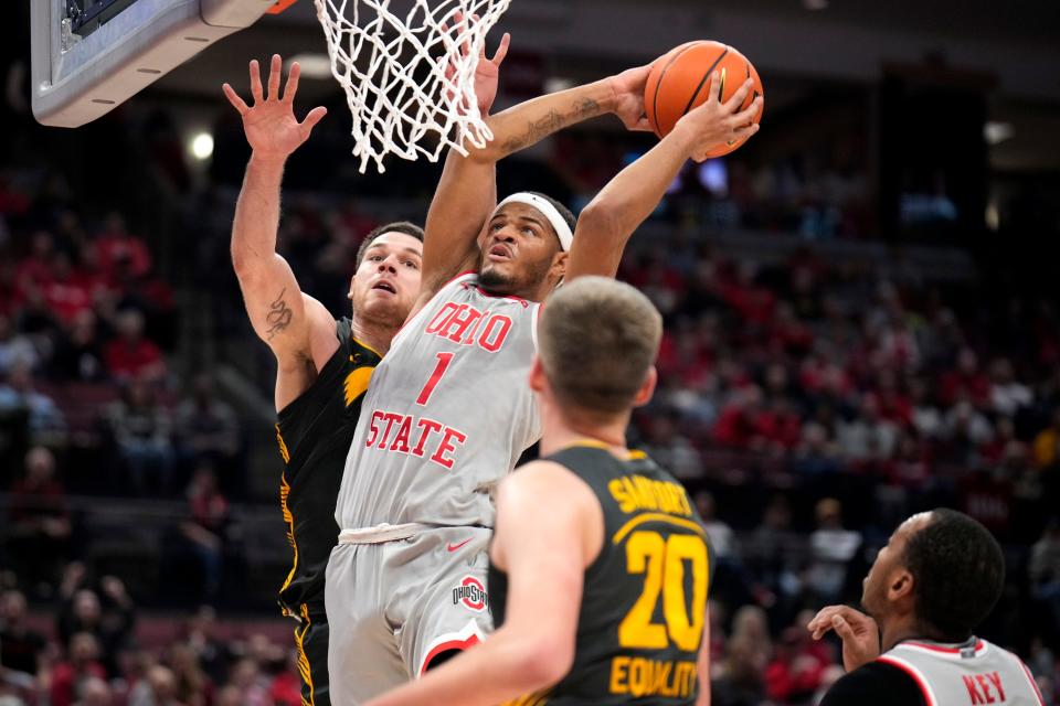 Ohio State guard Roddy Gayle Jr. scores while defended by Iowa's Filip Rebraca.