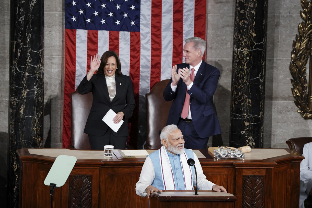 Vice President Kamala Harris stands as she is acknowledged by India