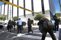 <p>UPS workers are escorted by San Francisco police at the scene of a shooting at a company facility on June 14, 2017 in San Francisco, California. (Photo by Justin Sullivan/Getty Images) </p>