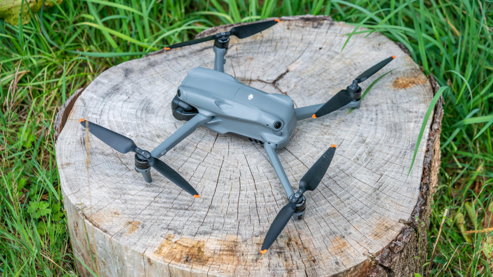 DJI Air 3 drone on a tree stump with arms and propellors in flight position