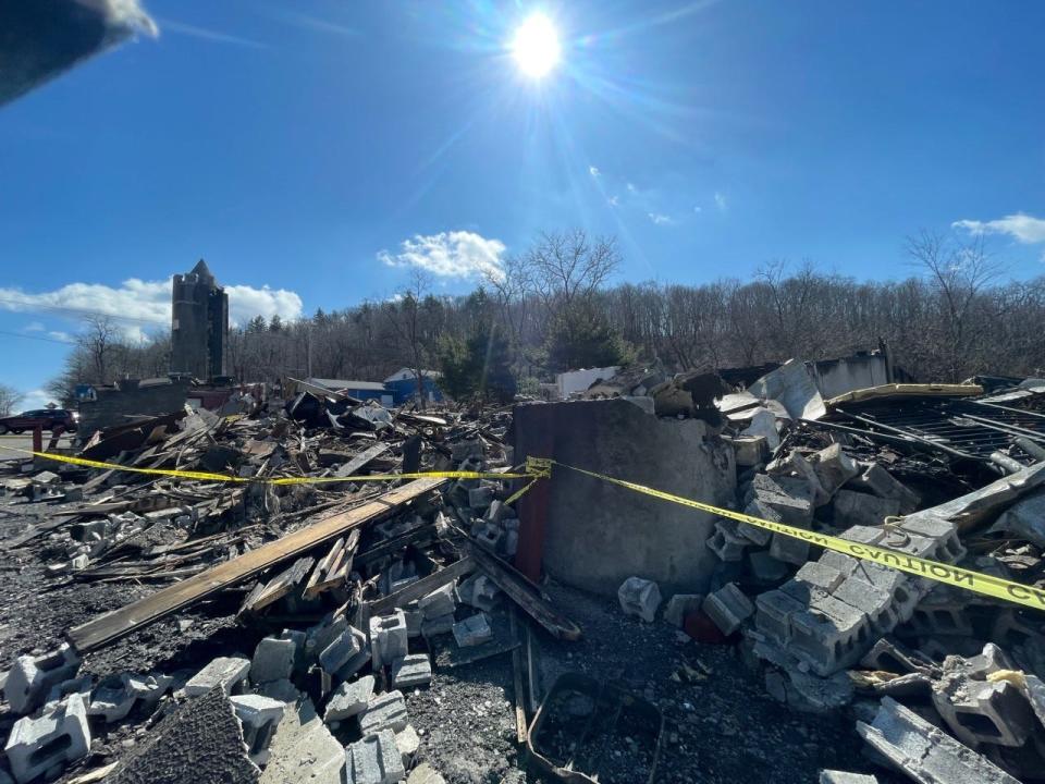 The walls of the Kings & Queens Restaurant and Pub, 4533 Lincoln Highway, were rocking, so a excavator was called in to take down what was left of the building after the fire Saturday.