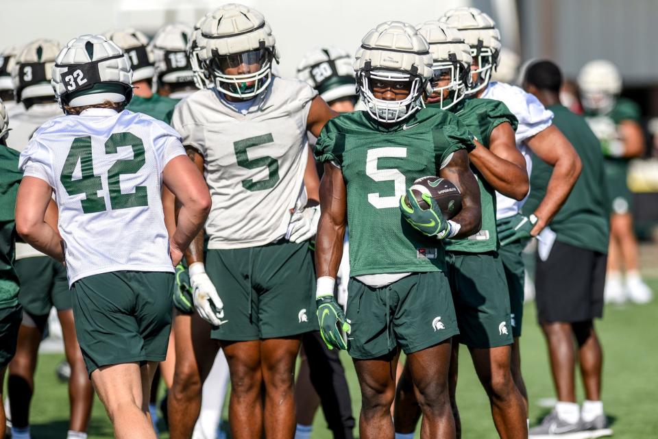 Michigan State running back Nathan Carter holds the ball during a drill during the opening day of MSU's football fall camp on Thursday, Aug. 3, 2023, in East Lansing.