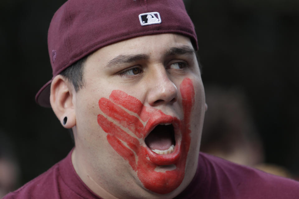 FILE - William Red Bear wears a red hand print image on his face as he marches in support of missing and murdered indigenous women during a rally to mark Indigenous Peoples Day, Oct. 14, 2019, in downtown Seattle. Native American people will celebrate their centuries-long history of resilience on Monday, Oct. 9, 2023, through ceremonies, dances and speeches. The events across the United States will come two years after President Joe Biden officially commemorated Indigenous Peoples Day. (AP Photo/Ted S. Warren, File)