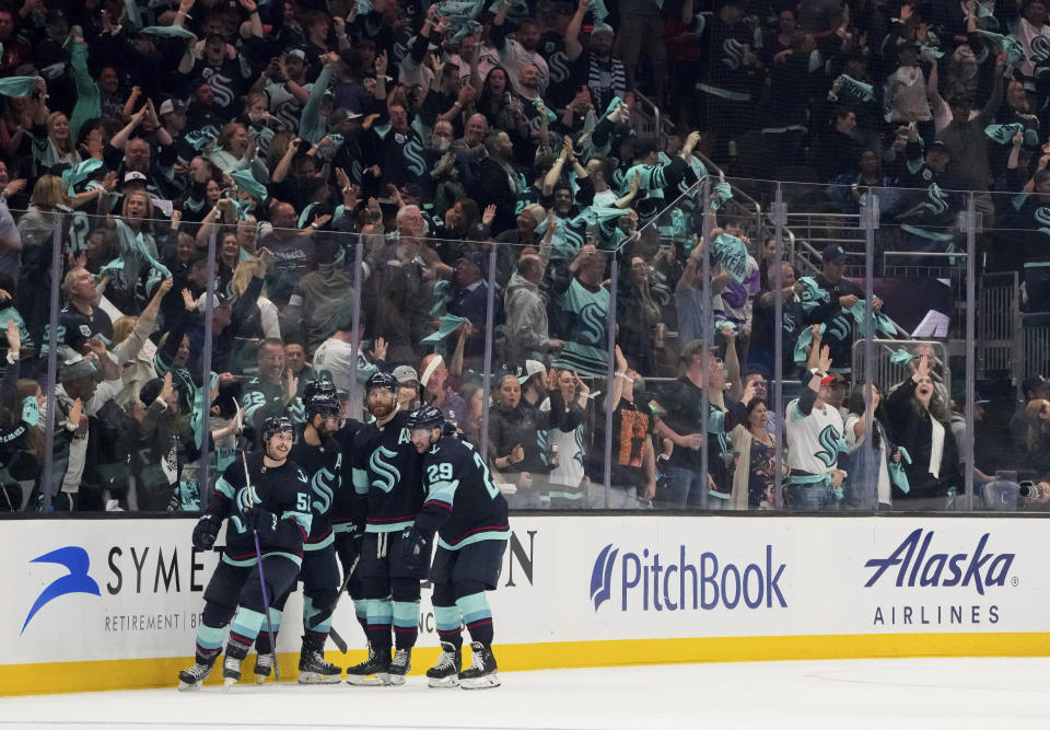 Seattle Kraken left wing Tye Kartye (52) celebrates his goal against the Dallas Stars with teammates Jordan Eberle, second from left, Adam Larsson, and Vince Dunn (29) during the second period of Game 6 of an NHL hockey Stanley Cup second-round playoff series Saturday, May 13, 2023, in Seattle. (AP Photo/Lindsey Wasson)