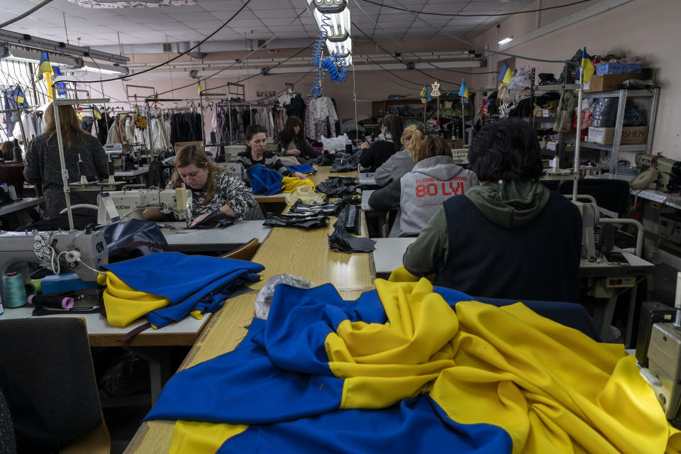 Volunteers sew Ukrainian flags and first aid kits at a workshop in Lviv, western Ukraine, Monday, March 14, 2022. (AP Photo/Bernat Armangue)