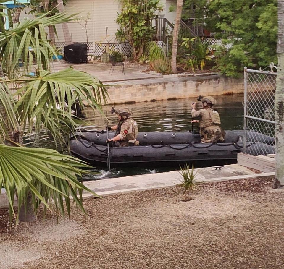 FBI agents arrive by dinghy on a canal behind a Geiger Key home they raided Friday, Dec. 16, 2022. Photo by Belinda Coyner