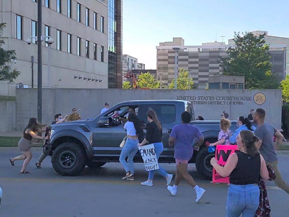 Protesters approach a pickup truck that attempted to run over abortion-rights protesters in Cedar Rapids, Iowa.