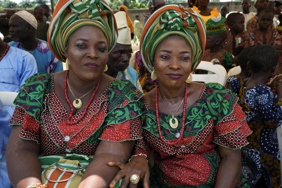 Twins Taye, Tijani, left, and Kehinde Tijani, 48, pose for a photo at the annual twins festival in Igbo-Ora South west Nigeria, Saturday, Oct. 8, 2022. The town holds the annual festival to celebrate the high number of twins and multiple births. (AP Photo/Sunday Alamba)