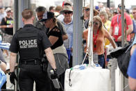 Secret Service Agents search fans as they enter the Fan Zone before the NASCAR Daytona 500 auto race at Daytona International Speedway, Sunday, Feb. 16, 2020, in Daytona Beach, Fla. Extra security measures were taken at the speedway because of the visit of President Donald Trump. (AP Photo/John Raoux)