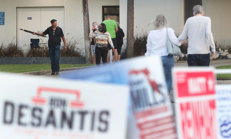 Voters make their way into the precinct as others head back to their cars after voting in the 2022 midterm election on Tuesday at the Daytona Beach Regional Library at City Island in Daytona Beach. “It’s so important,” said Jon Ewing, 65, of Daytona Beach, among the early birds. “If you don’t vote, your voice isn’t counted. You don’t have a right to complain if you’re not engaged.”
