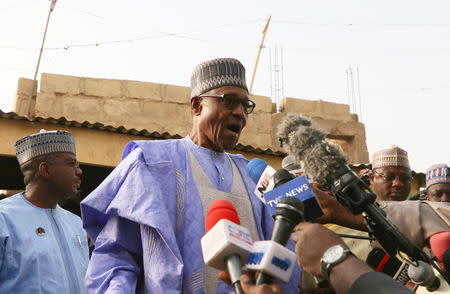 Nigerian President Muhammadu Buhari talks to the media as he arrives to cast a vote in Nigeria's presidential election at a polling station in Daura, Katsina State, Nigeria, February 23, 2019. REUTERS/Afolabi Sotunde