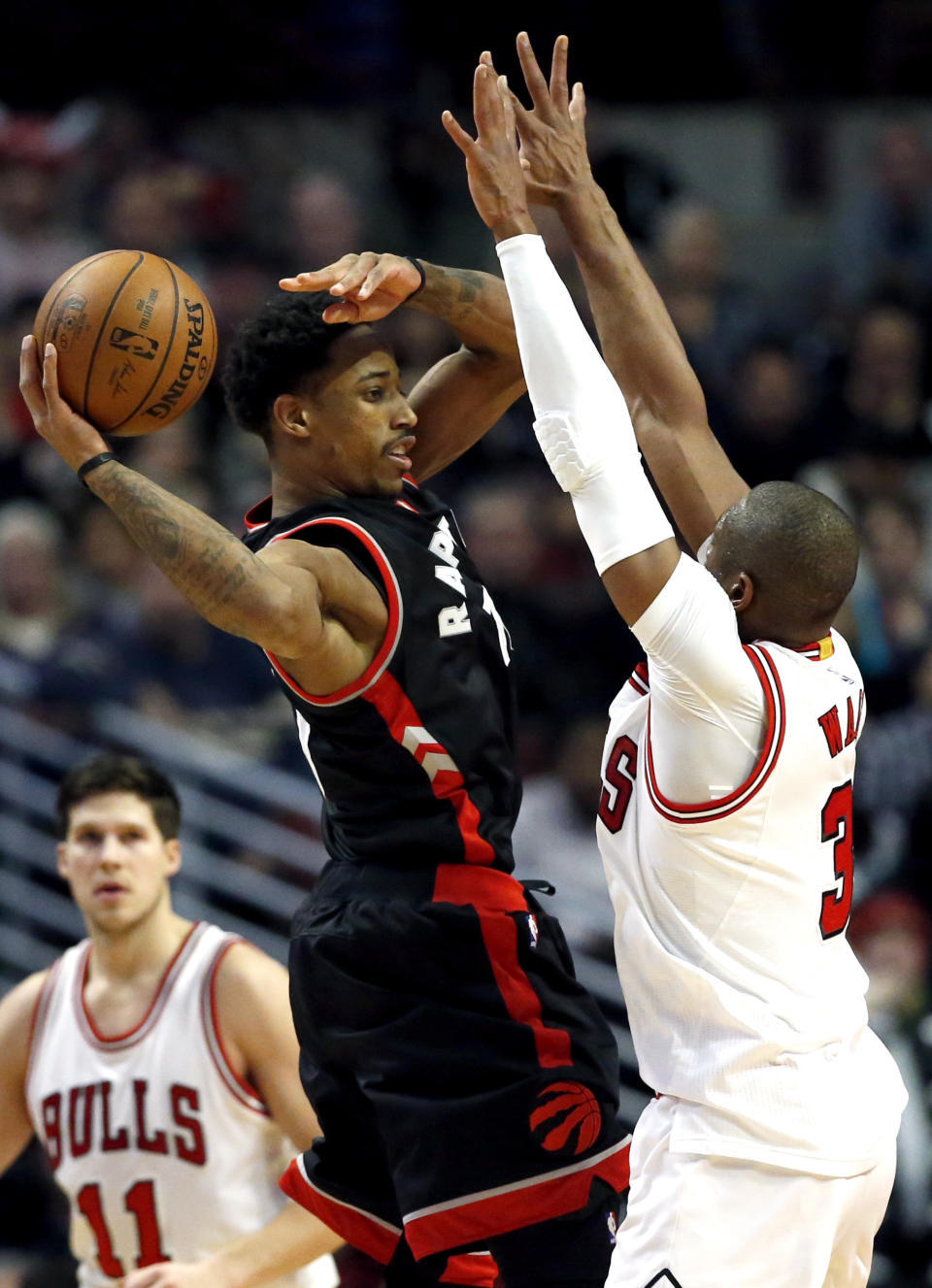 Toronto Raptors guard DeMar DeRozan, left, looks to pass as Chicago Bulls guard Dwyane Wade guards during the overtime of an NBA basketball game Saturday, Jan. 7, 2017, in Chicago. The Bulls won 123-118 in overtime. (AP Photo/Nam Y. Huh)