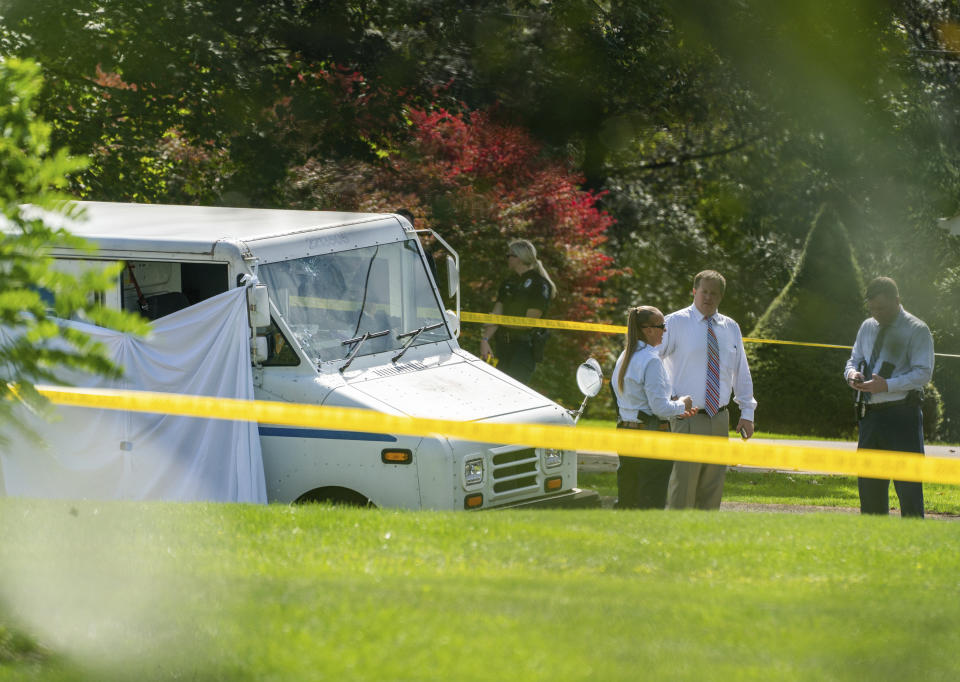 Police investigate the scene of a fatal shooting of a postal worker in front of a house on Suburban Ave. in Collier Township, Pa., outside of Pittsburgh, on Thursday, Oct. 7, 2021. (Andrew Rush/Pittsburgh Post-Gazette via AP)