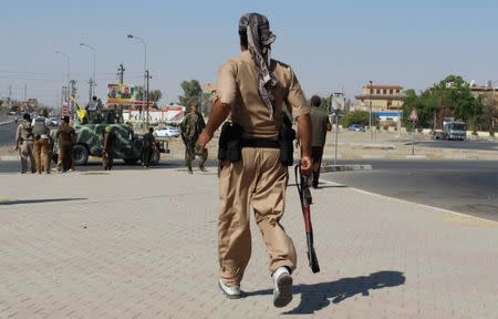 A member of Peshmerga forces carries his weapon north of Kirkuk, Iraq October 16, 2017. REUTERS/Stringer