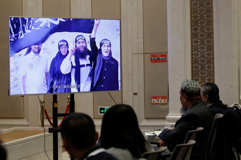 An image of what has been described as scenes of past violence is displayed in excerpts from a documentary "Fighting Terrorism in Xinjiang" at a news conference in Beijing