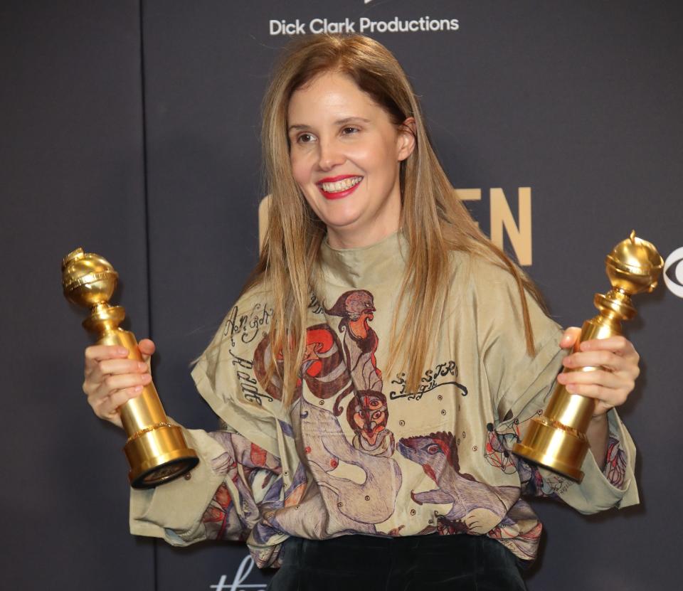 "Anatomy of a Fall" director Justine Triet poses with the awards for best screenplay and non-English language film.