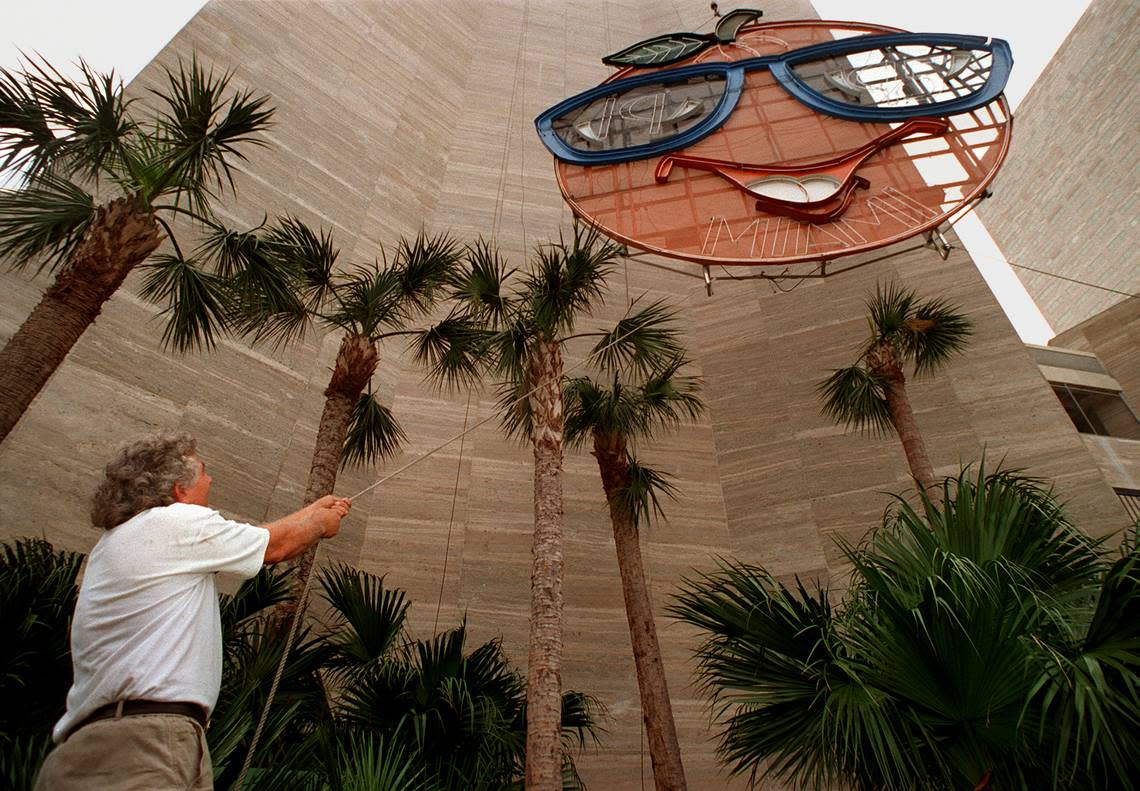 On Dec. 29, 1994, an employee for Mr. Neon, the company behind the Big Orange, steadies the fixture during installation at the Hotel Intercontinental in downtown Miami.