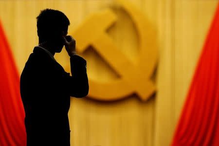 A security agent takes position at the Great Hall of the People during the opening session of the 19th National Congress of the Communist Party of China in Beijing, China October 18, 2017. REUTERS/Thomas Peter