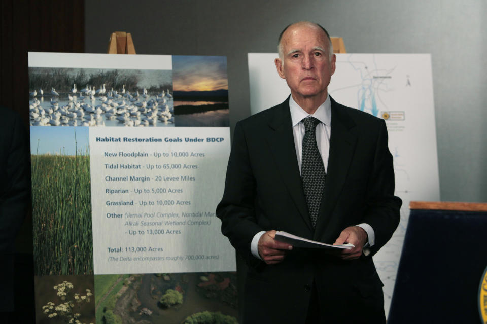 FILE - In this July 25, 2012, file photo, California Gov. Jerry Brown waits for the start of a news conference in Sacramento, Calif., to announce plans to build a giant twin tunnel system to move water from the Sacramento-San Joaquin River Delta to farmland and cities. Gov. Gavin Newsom officially abandoned Brown's plan, Thursday, May 2, 2019, opting to build a single tunnel with a different design and a lower price. (AP Photo/Rich Pedroncelli, File)