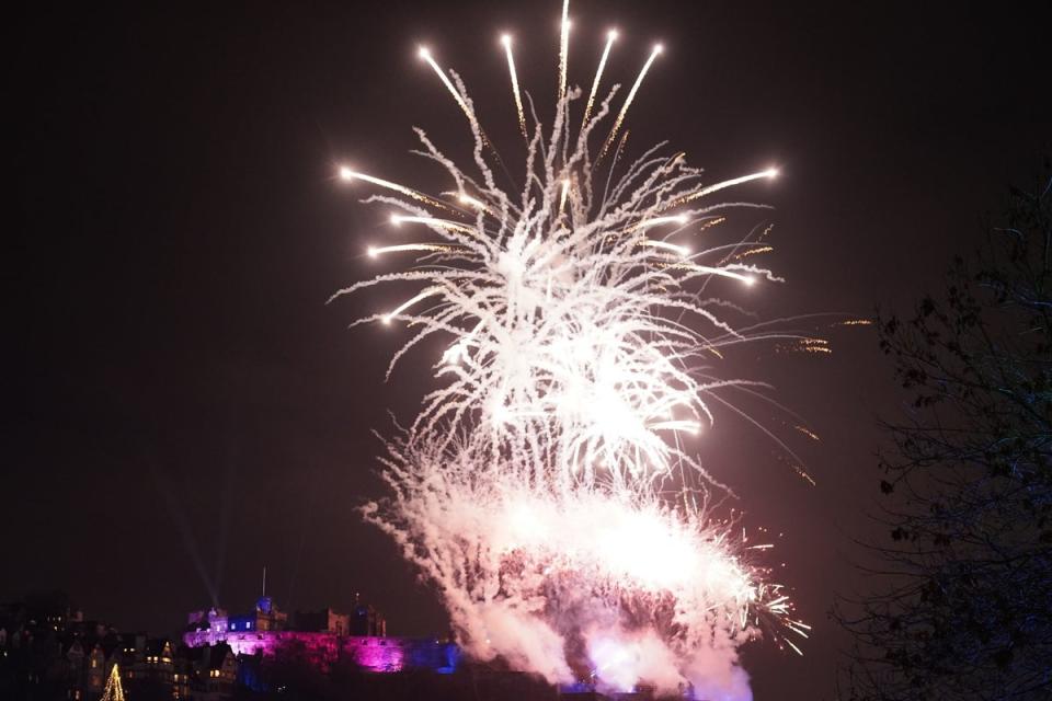 Fireworks explode over Edinburgh Castle as the city held the 30th Hogmanay street party (PA)