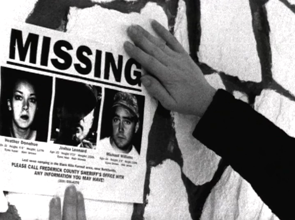 Someone putting up a "Missing" poster