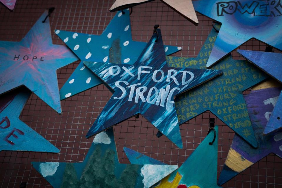 Hand-painted wooden stars are displayed to honor the one-year anniversary of the Oxford High School shooting in downtown Oxford on Wednesday, Nov. 30, 2022.