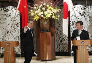 China' Foreign Minister Wang Yi, left, and his Japanese counterpart Toshimitsu Motegi conclude a press briefing in Tokyo on Tuesday, Nov. 24, 2020. Wang met Motegi on Tuesday to discuss ways to revive their pandemic-hit economies as well as regional concerns over China’s growing influence. (Issei Kato/Pool Photo via AP)