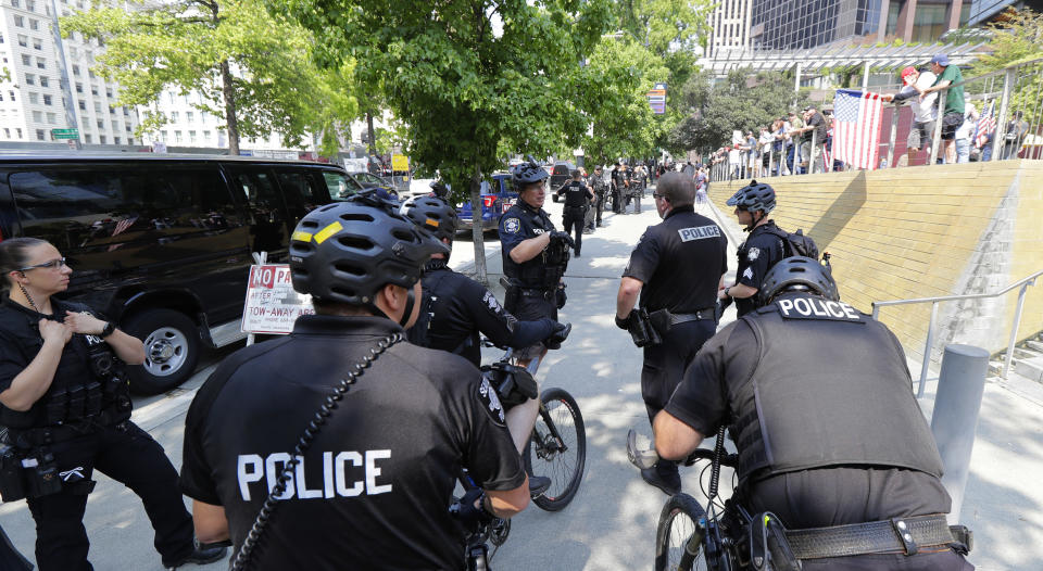 Seattle Police officers line the street in front of City Hall as they try to keep members of Patriot Prayer and other groups supporting gun rights and counter-protesters from anti-fascist groups separated prior to a rally, Saturday, Aug. 18, 2018, at City Hall in Seattle. (AP Photo/Ted S. Warren)