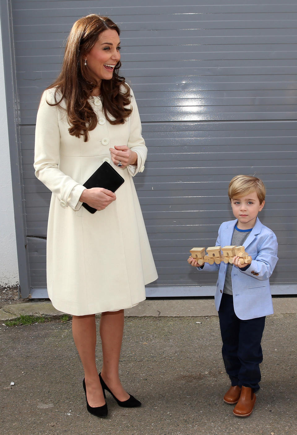 <p>The Duchess visited the set of ‘Downton Abbey’ in another tailored coat. Her pristine cream style was by Jojo Maman Bebe.<br><i>[Photo: PA]</i> </p>