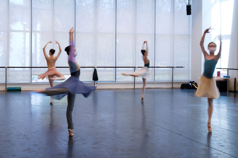 Shanghai Ballet dancers wearing masks practise in a dance studio in Shanghai