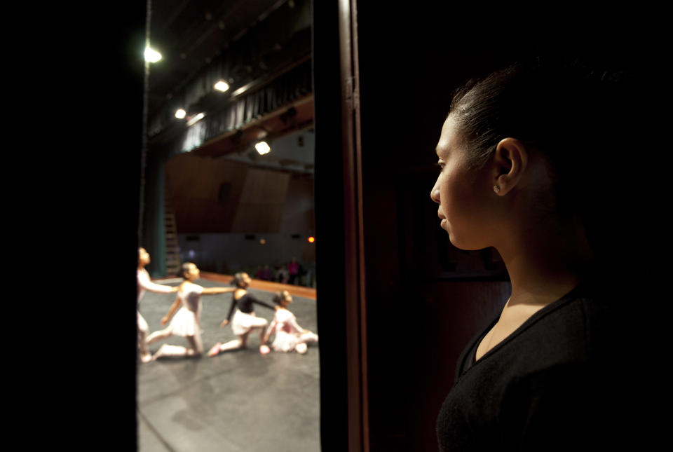 In this Sept. 3, 2012 photo, a ballet dancer watches others practice for a competition between ballet schools at the National Museum in Lima, Peru. Nearly 100 girls and boys from Colombia, Venezuela, Chile, France and Peru are submitting themselves to a week-long competition hoping to win medals from Peru's national ballet school _ and perhaps a grant to study in Miami. (AP Photo/Martin Mejia)