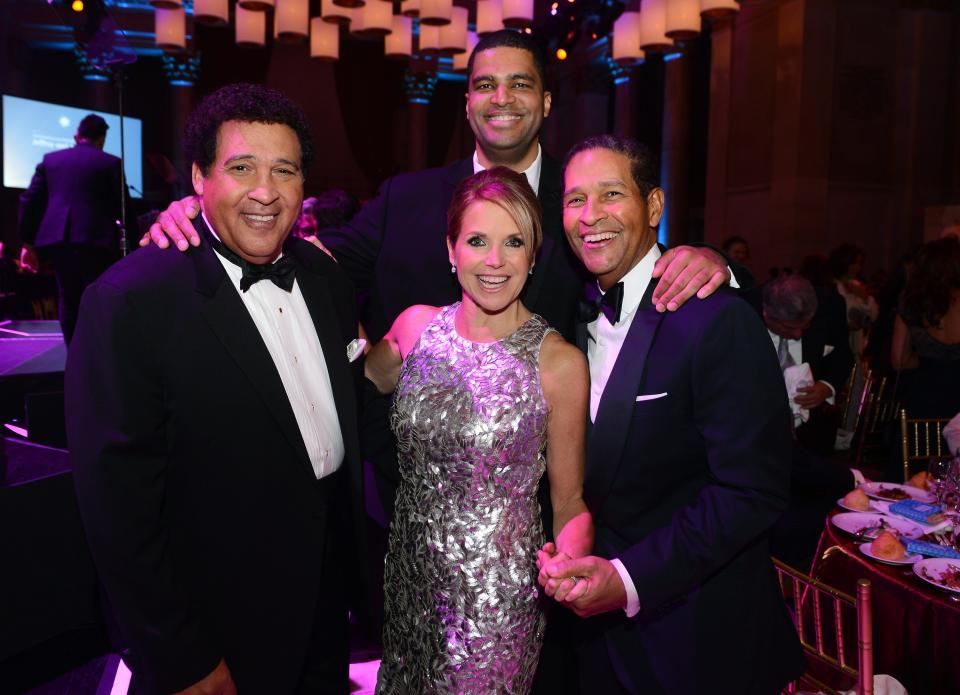 Katie Couric, second from left, poses with Bryant Grumbel (right) and his brother Greg (left) and son Brad Gumbel in 2014.