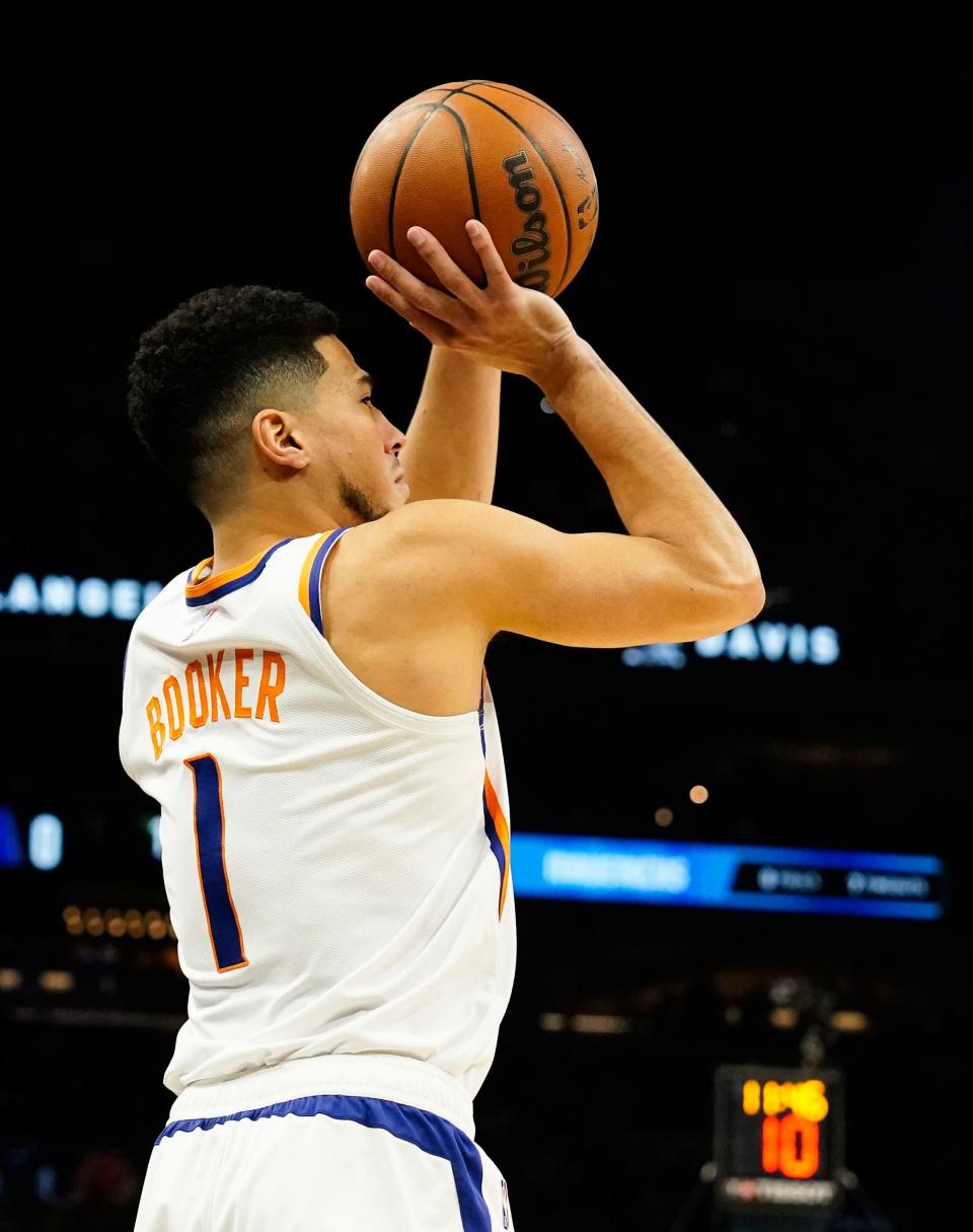 Nov 17, 2021; Phoenix, Arizona, USA; Phoenix Suns guard Devin Booker (1) shoots a jumper against the Dallas Mavericks at Footprint Center. Mandatory Credit: Rob Schumacher-Arizona Republic