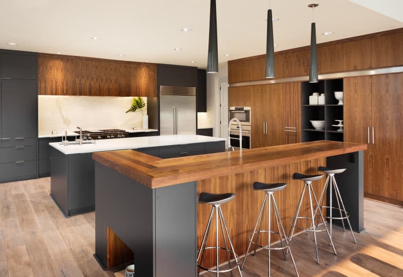 Beautiful Kitchen Interior with Two (double) Islands,  Two Sinks, Cabinets, and Hardwood Floors in New Luxury Home