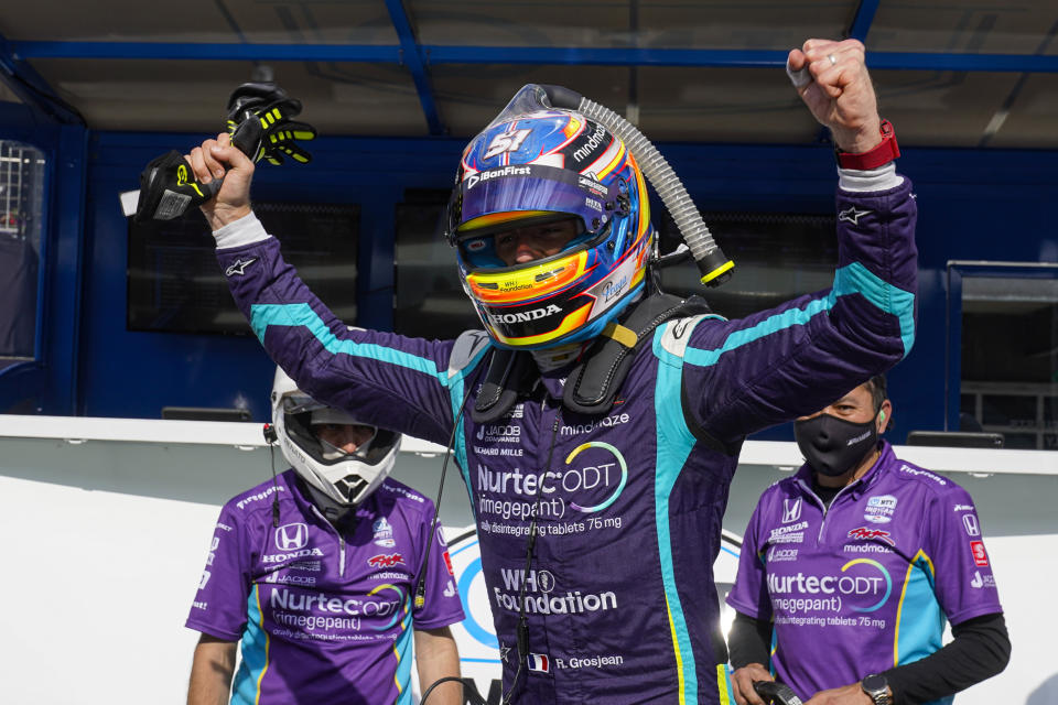 Romain Grosjean, of Switzerland, celebrates after winning the pole during qualifications for the IndyCar auto race at Indianapolis Motor Speedway in Indianapolis, Friday, May 14, 2021. (AP Photo/Michael Conroy)