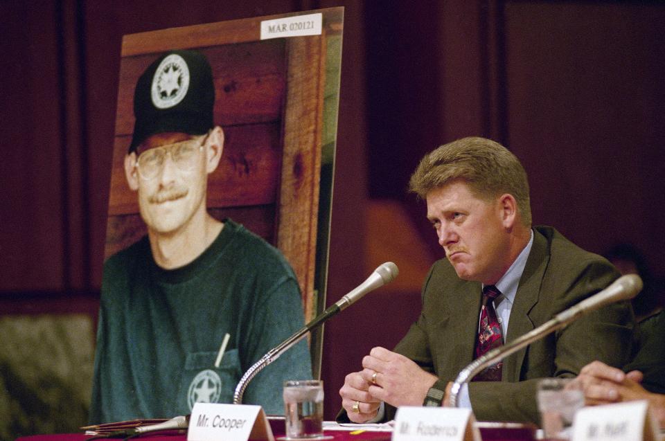U.S. Marshal Larry Cooper testifies on Capitol Hill in Washington, D.C., on Friday, Sept. 15, 1995, before a Senate Judiciary subcommittee, which was holding hearings on the 1992 raid on the cabin of white separatist Randy Weaver in Ruby Ridge, Idaho. The photo at left is of Deputy U.S. Marshal William Degan, of Quincy, who was killed during the shootout at the cabin.