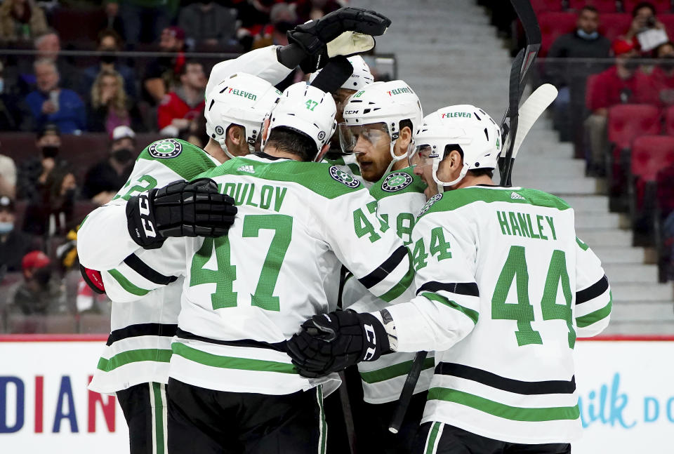 Dallas Stars' Michael Raffl (18) celebrates his goal with teammates during the first period of an NHL hockey game against the Ottawa Senators, in Ottawa, Ontario, Sunday, Oct. 17, 2021. (Sean Kilpatrick/The Canadian Press via AP)