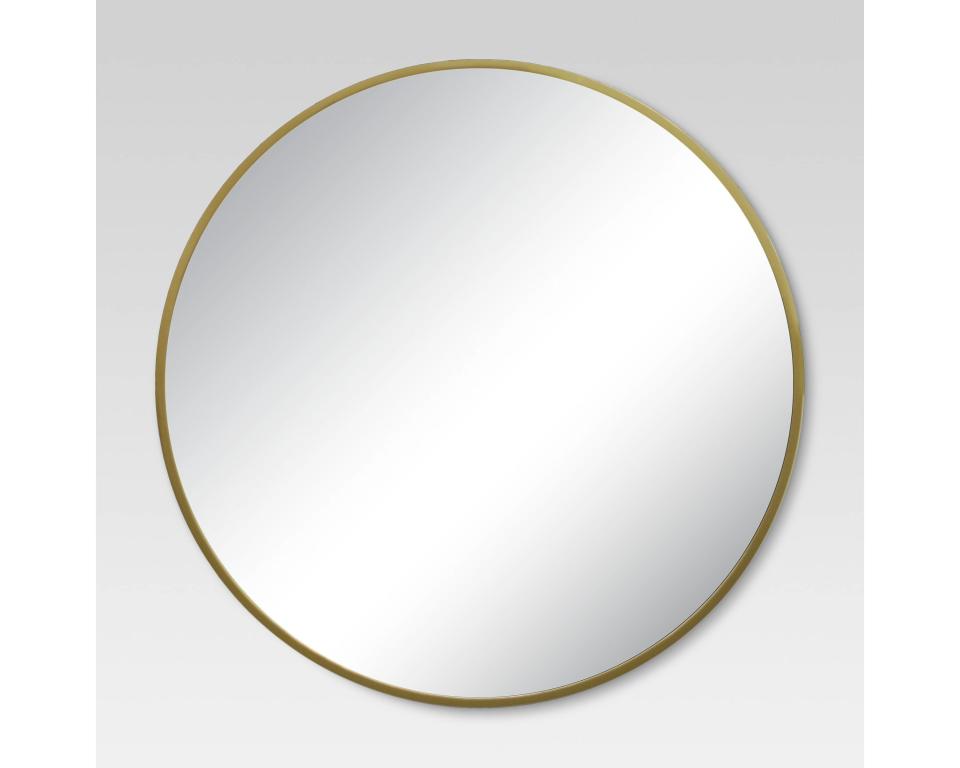 Get it at <a href="https://www.target.com/p/round-decorative-wall-mirror-brass-project-62-153/-/A-50301089#lnk=newtab" target="_blank">Target, $50</a>.