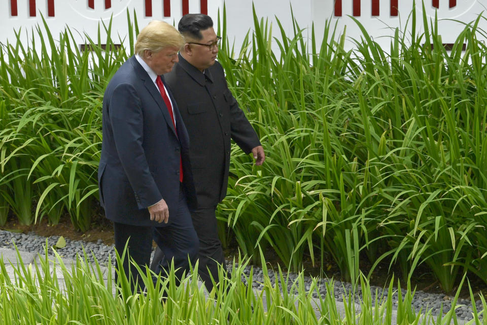 U.S. President Donald Trump and North Korea leader Kim Jong Un walk from lunch at the Capella resort on Sentosa Island Tuesday, June 12, 2018 in Singapore. (Pool Photo by Anthony Wallace via AP)