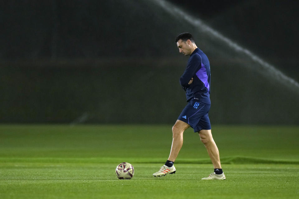 Argentina's head coach Lionel Scaloni plays a ball during a training session of Argentina national team ahead of the final soccer match between Argentina and France in Doha, Qatar, Thursday, Dec. 15, 2022. (AP Photo/Francisco Seco)