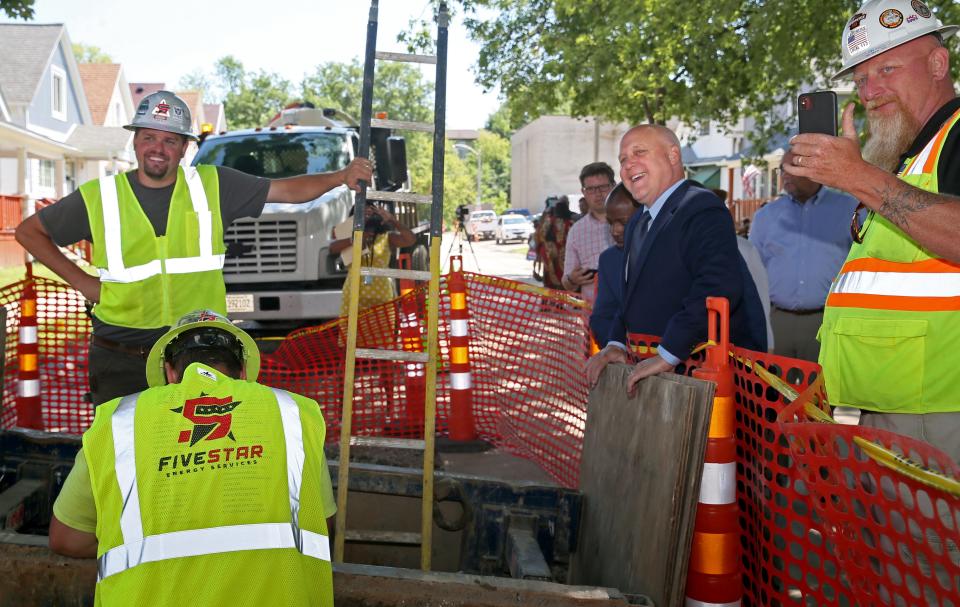 White House Infrastructure Coordinator Mitch Landrieu, right center, is joined by Milwaukee Mayor Cavalier Johnson, on his left, on Wednesday, July 13, 2022, to view a construction site where lead pipe replacement was underway on South 12th street in Milwaukee.  Landrieu was visiting Milwaukee to talk about President Joe Biden’s bipartisan Infrastructure law that is rebuilding America’s infrastructure  that includes improving roads and bridges, replacing lead pipes to provide clean water and expanding high speed are among some of the  projects that are happening nation wide.