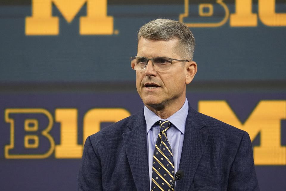 In the latest twist of an NCAA investigation into recruiting violations, it appears Michigan head coach Jim Harbaugh will miss the first few games of this season after all. (AP Photo/Darron Cummings)