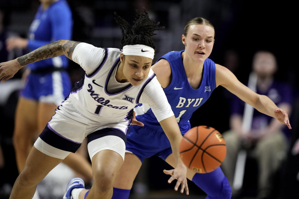 Kansas State guard Zyanna Walker, left, and BYU guard Amari Whiting chase after a loose ball during the first half of an NCAA college basketball game Saturday, Jan. 27, 2024, in Manhattan, Kan. (AP Photo/Charlie Riedel)