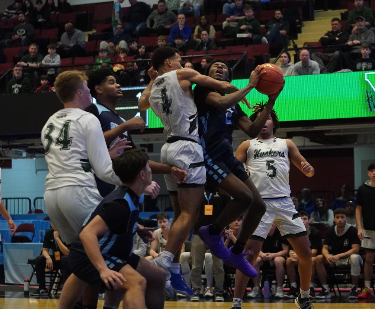 Suffern's Jeff Joseph (2) and Yorktown's Brandan Montero (4) collide at the basket during the boys basketball Class AA semifinal game at the Westchester County Center in White Plains on Tuesday, Feb. 27, 2024.