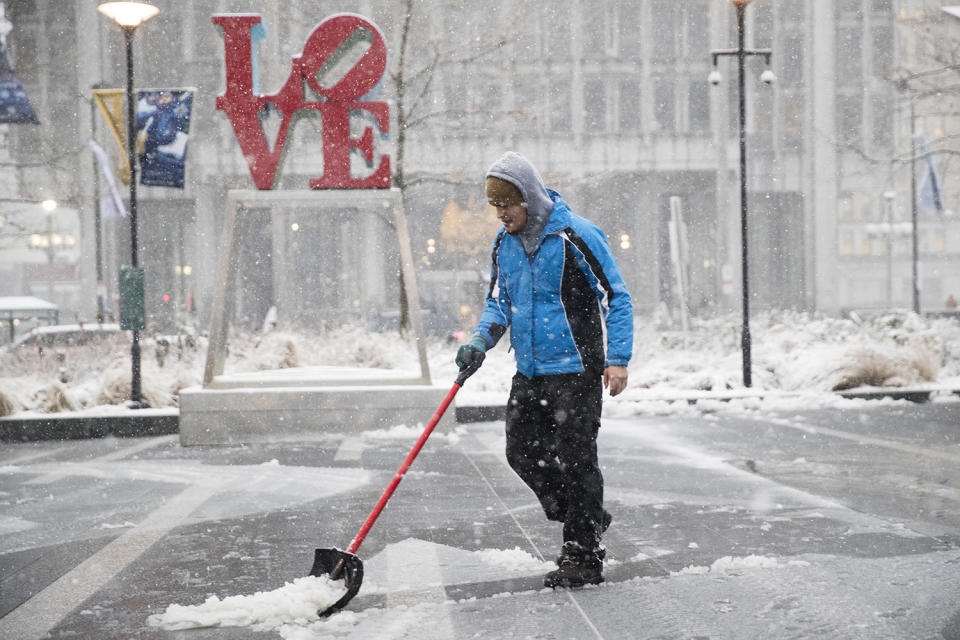 <p>A man clears snow from Dilworth Park during a winter storm in Philadelphia, Thursday, Feb. 9, 2017. A powerful, fast-moving storm swept through the northeastern U.S. Thursday, making for a slippery morning commute and leaving some residents bracing for blizzard conditions. (Photo: Matt Rourke/AP) </p>